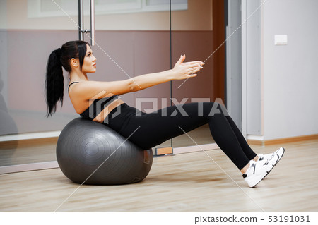 Fitness Girl. Sexy athletic girl working out in gym. Fitness woman doing exercise 53191031