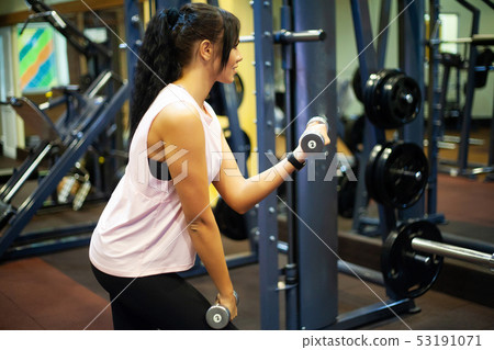 Fitness Girl. Sexy athletic girl working out in gym. Fitness woman doing exercise Fitness Girl. Sexy athletic girl working out in gym. Fitness woman doing exercise 53191071