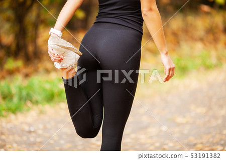 Fitness Girl. Young fitness woman runner stretching legs before run 53191382