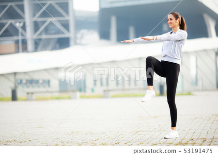 Fitness Girl. Young woman doing exercises in the park. 53191475