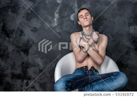 Handsome skinny guy holding a chain. Black Handsome skinny guy holding a chain. Black 53192072