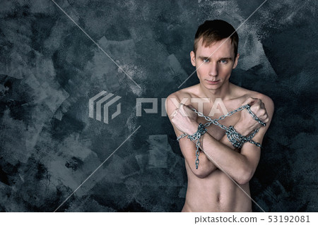 Handsome skinny guy holding a chain. Black Handsome skinny guy holding a chain. Black 53192081