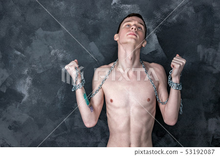 Handsome skinny guy holding a chain. Black Handsome skinny guy holding a chain. Black 53192087