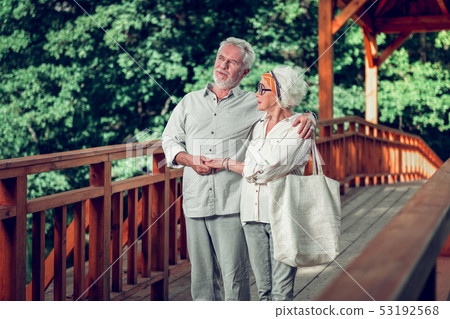 Handsome man tenderly hugging the charming aging beautiful alluring wife Handsome man tenderly hugging the charming aging beautiful alluring wife 53192568