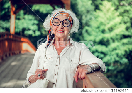 Face portrait of old dame holding a bag in hands Face portrait of old dame holding a bag in hands 53192611