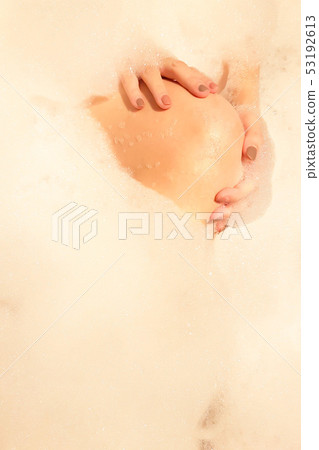 Hands and knee of lady on bubble foam background Hands and knee of lady on bubble foam background 53192613