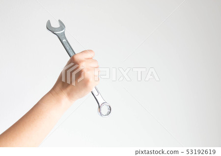 Hand clench a ring spanner tightly on white. Hand clench a ring spanner tightly on white. 53192619