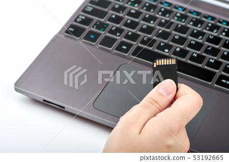 View of a woman holding a black SD card in her View of a woman holding a black SD card in her 53192665