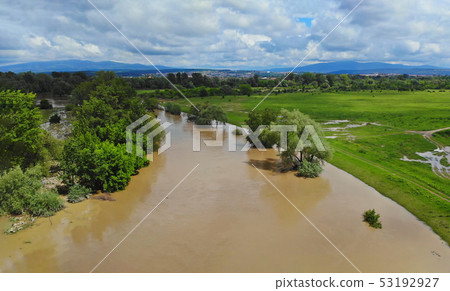 Rural village along river water at high levels 53192927