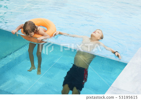 Two brothers in swimming pool 53195615