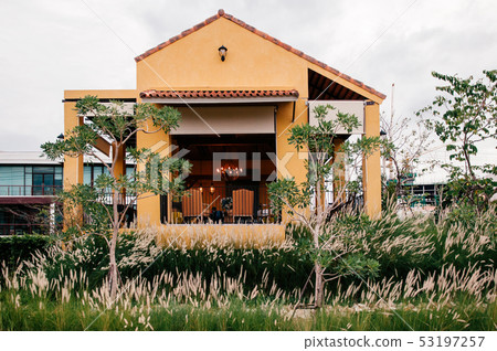 Colourful Mediterranean style building in grass Colourful Mediterranean style building in grass 53197257