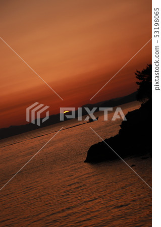 Fishing boat floating in the sea at sunset 53198065