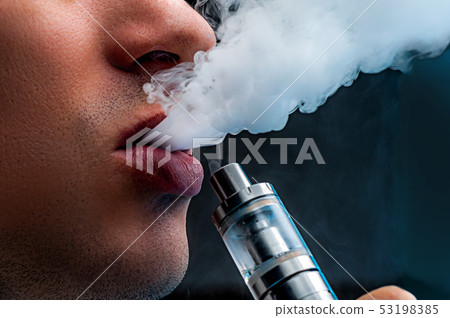 Close-up - young man vaping e-cigarette Close-up - young man vaping e-cigarette 53198385