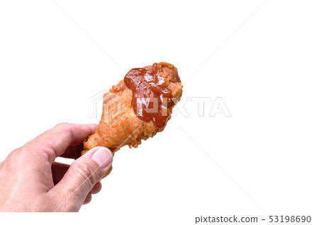hand holding fried chicken leg dressing ketchup  53198690