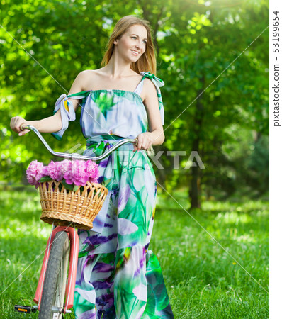 Beautiful blond woman wearing a nice dress having 53199654