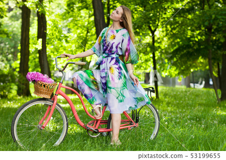 Beautiful blond woman wearing a nice dress having 53199655