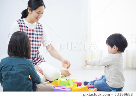 Nursery teacher and children, building blocks Nursery teacher and children, building blocks 53199698