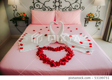 The bed in a luxurious hotel decorated with rose. 53199731