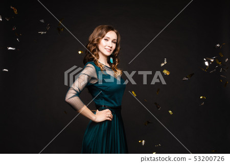Elegant woman in long black dress posing in studio 53200726
