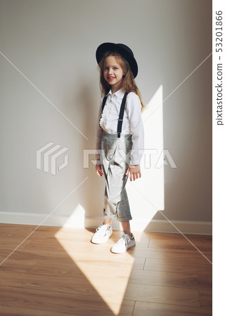cute little girl with black hat at home 53201866