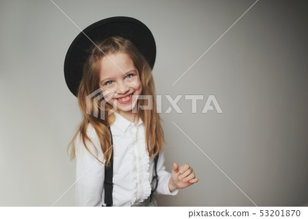 cute little girl with black hat at home 53201870