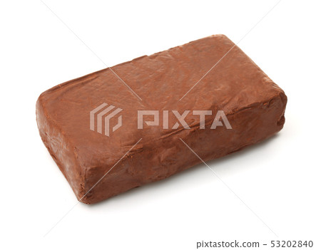Piece of natural raw red modeling clay 53202840