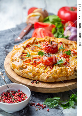 Open pie with potatoes, bacon, onions and 53203241