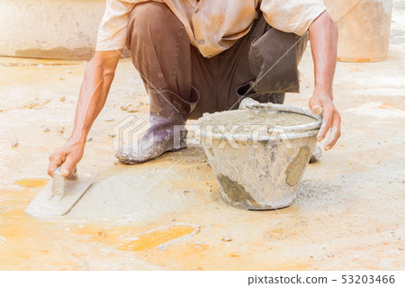 construction workers were plastering repair floor 53203466