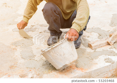 construction workers were plastering repair floor 53203468