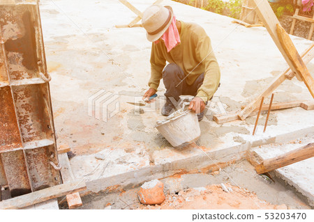 construction workers were plastering repair floor 53203470