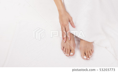 Close up view oaf a female fet on a terry towel. Pedicure, spa and wellness concept Close up view oaf a female fet on a terry towel. Pedicure, spa and wellness concept 53203773