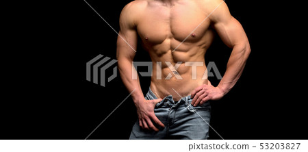 Shirtless male torso over dark background. Shape male abdomen muscles. 53203827