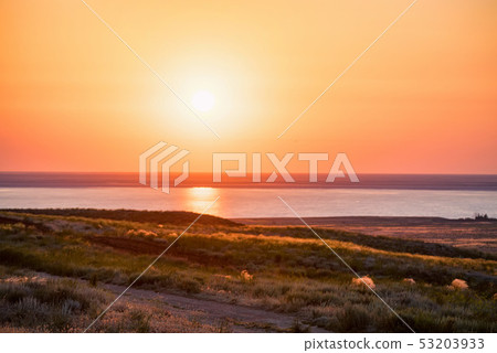 Beautiful view of sunset at salt lake Baskunchak in Astrakhan region, Russia Beautiful view of sunset at salt lake Baskunchak in Astrakhan region, Russia 53203933