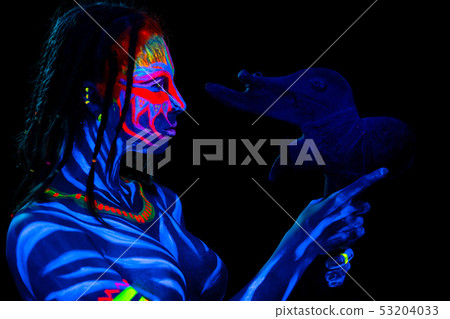 Portrait of Young naked bodyarted savage woman in blue glowing ultraviolet paint with primeval Portrait of Young naked bodyarted savage woman in blue glowing ultraviolet paint with primeval 53204033