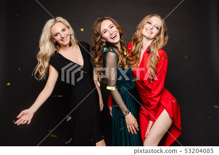 Three gorgeous ladies in evening dresses having 53204085