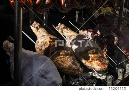 pork skewered on an iron cooking on coals 53204315