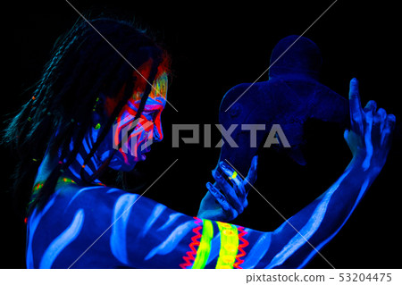 Portrait of Young naked bodyarted savage woman in blue glowing ultraviolet paint with primeval Portrait of Young naked bodyarted savage woman in blue glowing ultraviolet paint with primeval 53204475