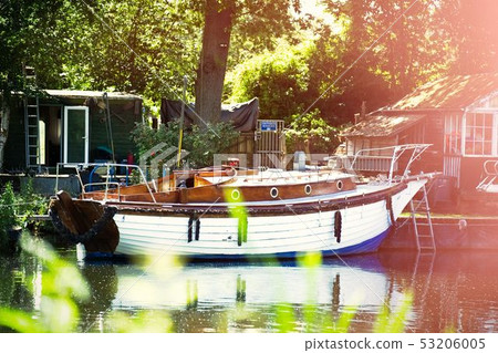 Boat on the shore of a misty river on a summer evening Boat on the shore of a misty river on a summer evening 53206005