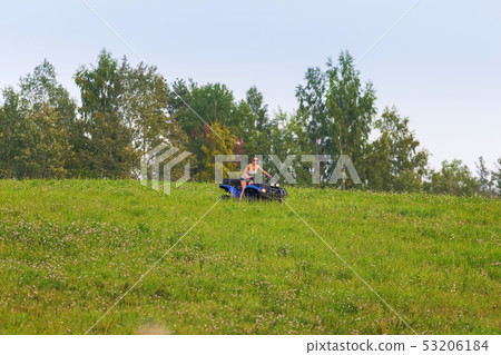 Elegant woman riding quadrocycle atv Elegant woman riding quadrocycle atv 53206184
