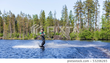Young pretty slim brunette woman in wetsuit riding 53206265