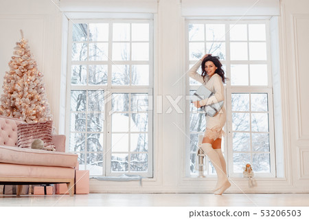 Beautiful young girl in white dress posing on camera. Christmas concept Beautiful young girl in white dress posing on camera. Christmas concept 53206503