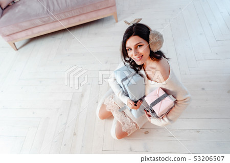 Beautiful young girl in white dress posing on camera. Christmas concept Beautiful young girl in white dress posing on camera. Christmas concept 53206507