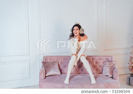 Young lady white caucasian woman in white dress posing in room Young lady white caucasian woman in white dress posing in room 53206509