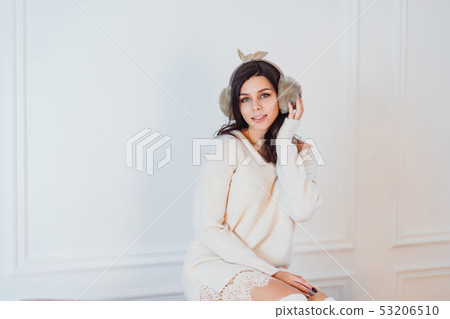 Young lady white caucasian woman in white dress posing in room Young lady white caucasian woman in white dress posing in room 53206510