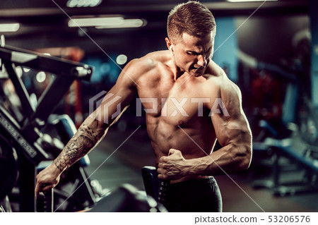 Strong Bodybuilder Doing Heavy Weight Exercise For Back On Machine Strong Bodybuilder Doing Heavy Weight Exercise For Back On Machine 53206576