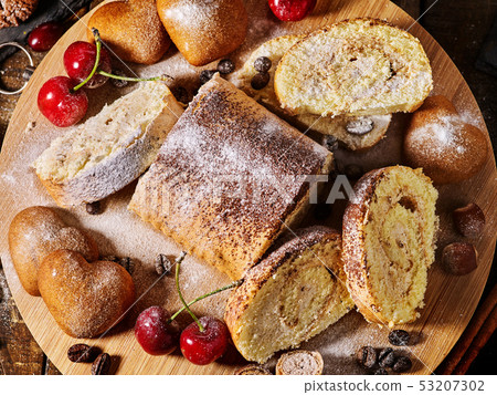 Sand chocolate cookies heart shape and rolled cake with cherry 53207302