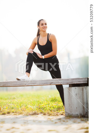 Portrait of beautiful sporty woman 20s in sportswear doing push-ups, and listening to music with Portrait of beautiful sporty woman 20s in sportswear doing push-ups, and listening to music with 53209779