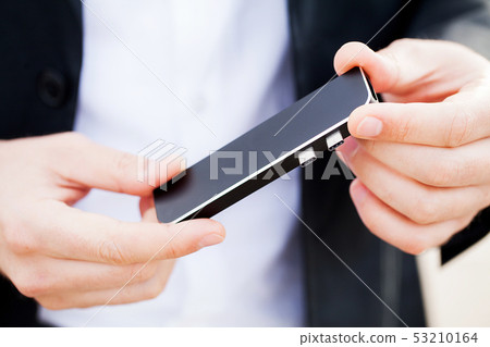 Man holding mini adapter for laptops and flash memory Man holding mini adapter for laptops and flash memory 53210164