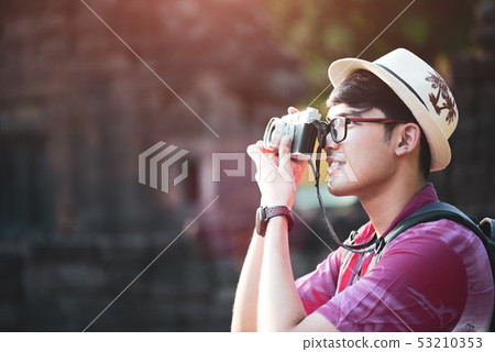 Young Man Photographer Traveler with backpack 53210353