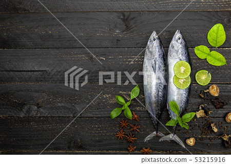 Fresh skipjack tuna fish on dark black wooden 53215916